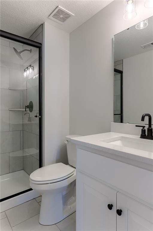 1308 N Holland Dr, Independence, MO 64056 - full bath featuring a textured ceiling, toilet, a shower stall, tile patterned flooring, and vanity