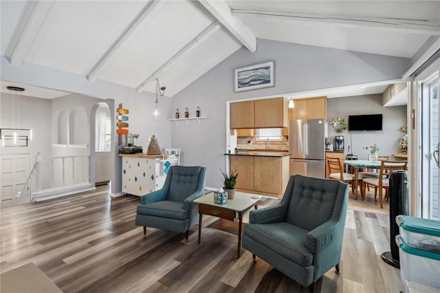 5101 NW Downing St, Blue Springs, MO 64015 - sitting room featuring wood finished floors, beam ceiling, arched walkways, high vaulted ceiling, and baseboards