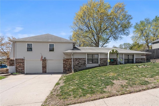 5101 NW Downing St, Blue Springs, MO 64015 - view of front of house with an attached garage, brick siding, and concrete driveway