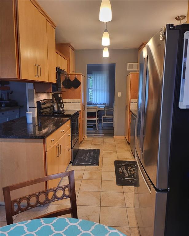 5101 NW Downing St, Blue Springs, MO 64015 - kitchen with freestanding refrigerator, black range with electric stovetop, light tile patterned flooring, and dishwasher
