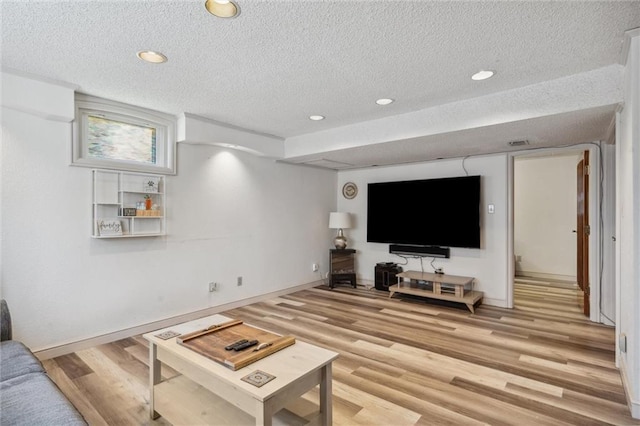 5101 NW Downing St, Blue Springs, MO 64015 - living room with light wood-style floors, a textured ceiling, recessed lighting, and baseboards