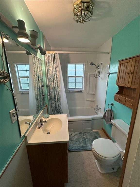 full bath with toilet, shower / bath combo, vanity, and plenty of natural light