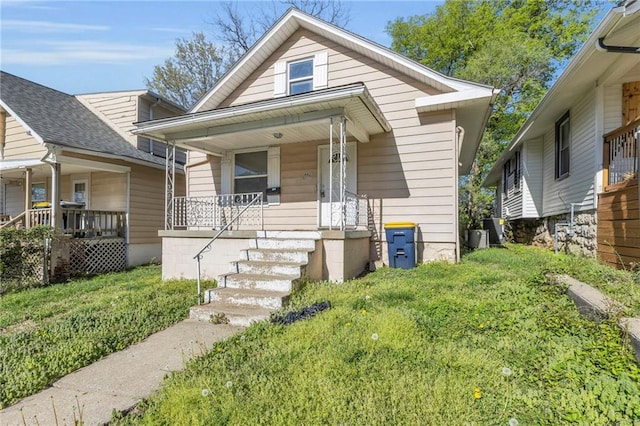 442 N Colorado Ave, Kansas City, MO 64123 - bungalow with stairway, a porch, and central AC unit