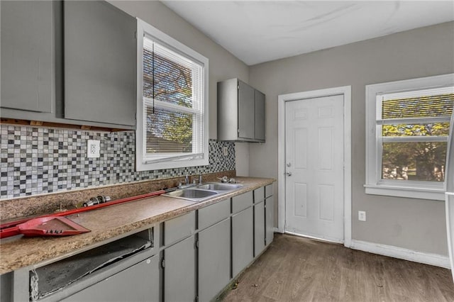 442 N Colorado Ave, Kansas City, MO 64123 - kitchen with a wealth of natural light, wood finished floors, gray cabinetry, and a sink