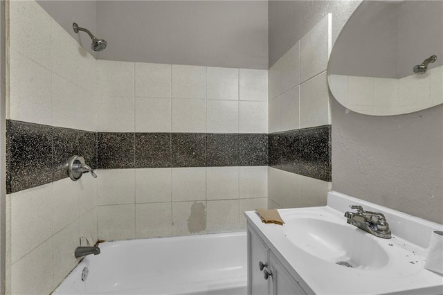 442 N Colorado Ave, Kansas City, MO 64123 - bathroom featuring a textured wall, vanity, and shower / tub combination