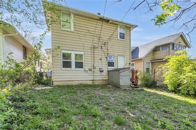 442 N Colorado Ave, Kansas City, MO 64123 - rear view of house featuring a storage unit and fence