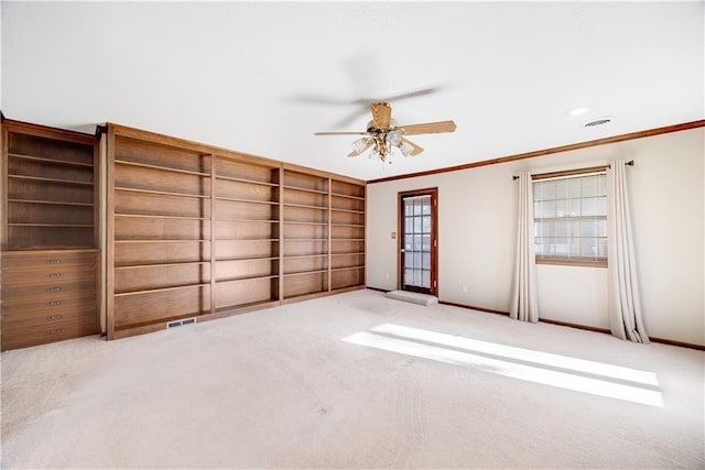 1707 NW Ashton Dr, Blue Springs, MO 64015 - carpeted spare room with ornamental molding, baseboards, a ceiling fan, and visible vents