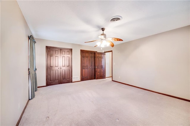 1707 NW Ashton Dr, Blue Springs, MO 64015 - unfurnished bedroom featuring visible vents, light colored carpet, two closets, and baseboards