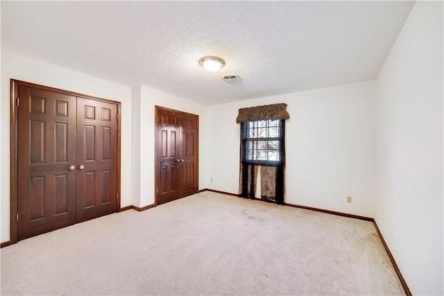 1707 NW Ashton Dr, Blue Springs, MO 64015 - unfurnished bedroom featuring visible vents, baseboards, a closet, a textured ceiling, and light carpet