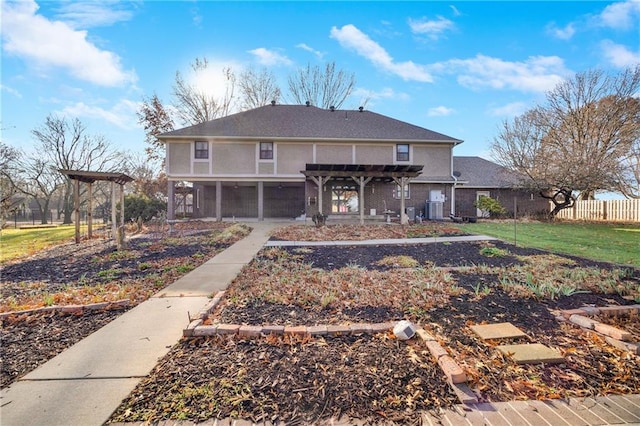 1707 NW Ashton Dr, Blue Springs, MO 64015 - traditional-style house with a pergola, a front yard, and fence