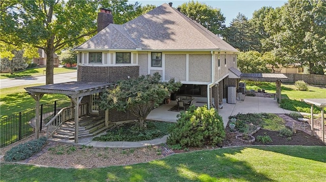 1707 NW Ashton Dr, Blue Springs, MO 64015 - view of front of property with a patio area, a front yard, fence, and a chimney