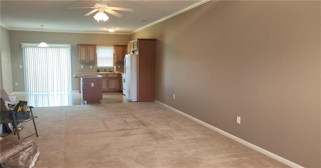 1219 S 3rd St, Louisburg, KS 66053 - kitchen featuring freestanding refrigerator, ornamental molding, a ceiling fan, light carpet, and open floor plan