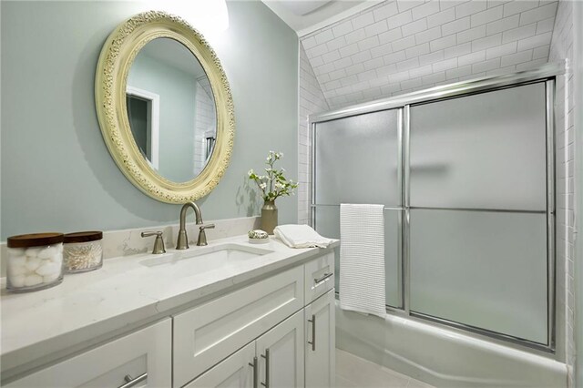 full bathroom featuring vanity and combined bath / shower with glass door