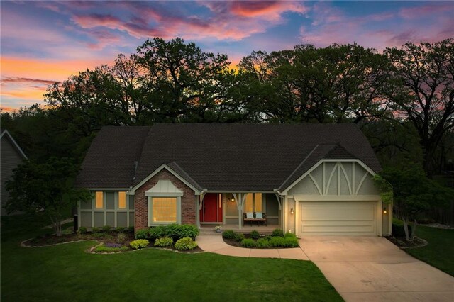 ranch-style house with a garage, a porch, driveway, and a front yard