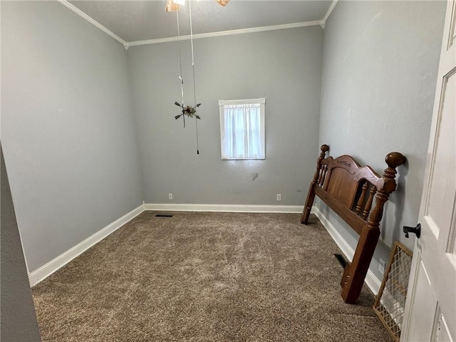 carpeted spare room with baseboards, ornamental molding, and ceiling fan