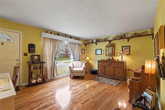 sitting room featuring baseboards and wood finished floors