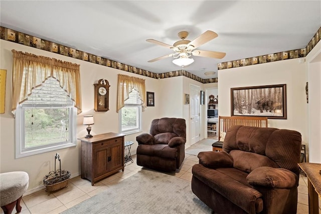 living area with a ceiling fan and light tile patterned floors
