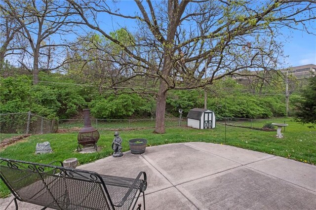 view of patio featuring a fenced backyard, an outbuilding, and a storage shed
