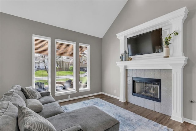 16754 W 156th Ter, Olathe, KS 66062 - living room featuring lofted ceiling, wood finished floors, a tile fireplace, and baseboards