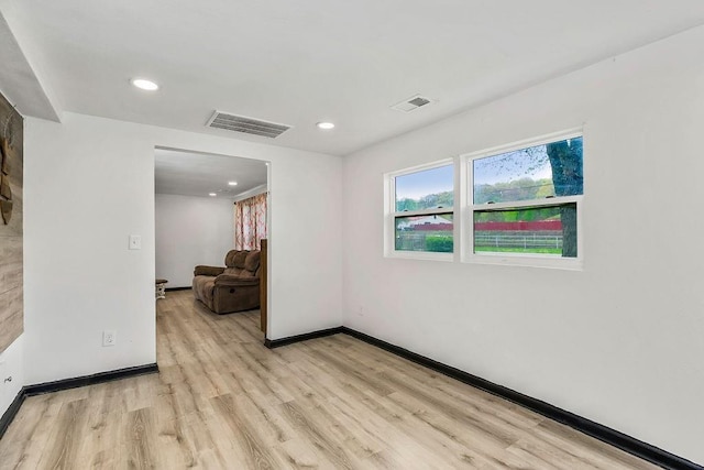 empty room with light wood finished floors, baseboards, visible vents, and recessed lighting