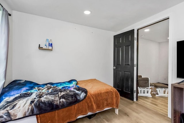 bedroom with light wood-style flooring and recessed lighting