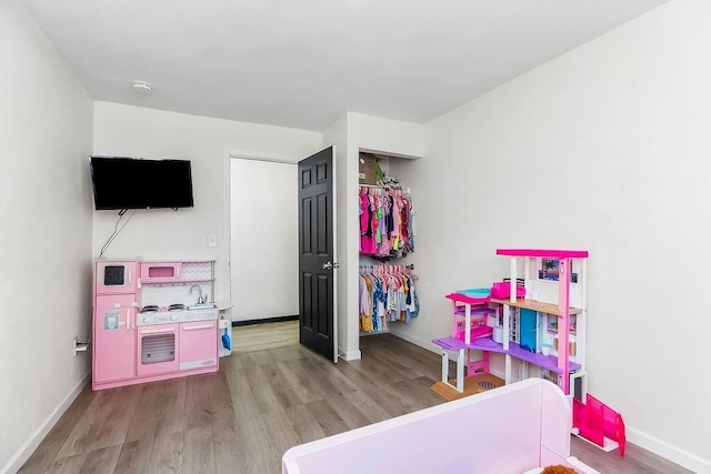 bedroom featuring baseboards and light wood-style floors