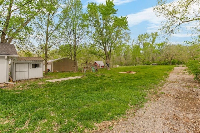 view of yard with a storage unit and an outbuilding