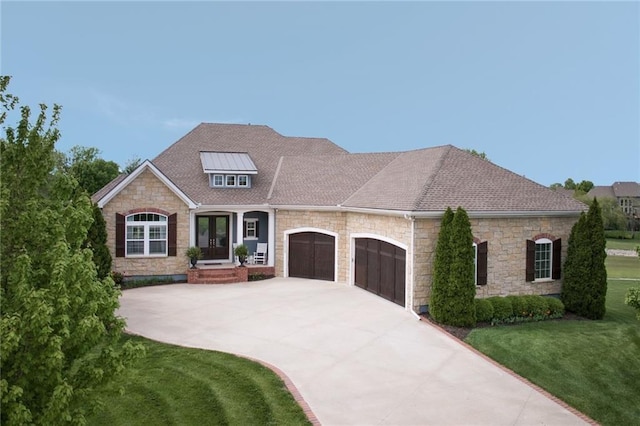 24212 W 69th St, Shawnee, KS 66226 - view of front of house featuring french doors, stone siding, an attached garage, a front lawn, and driveway