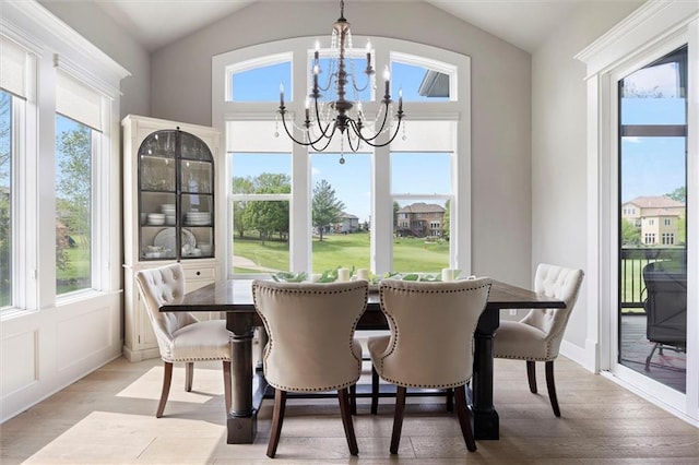 24212 W 69th St, Shawnee, KS 66226 - dining area featuring a chandelier, vaulted ceiling, and light wood-style floors