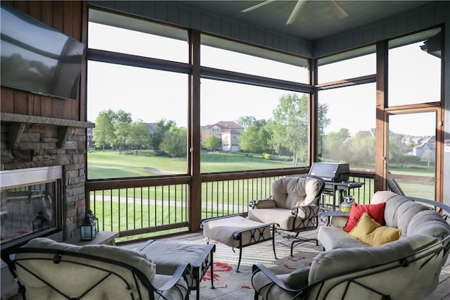 24212 W 69th St, Shawnee, KS 66226 - sunroom with ceiling fan, an outdoor living space with a fireplace, and plenty of natural light