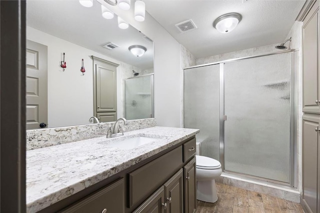 24212 W 69th St, Shawnee, KS 66226 - full bathroom featuring a shower stall, wood finished floors, toilet, and vanity
