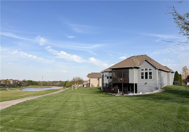 24212 W 69th St, Shawnee, KS 66226 - view of home's exterior featuring a yard, a sunroom, a water view, and stairway