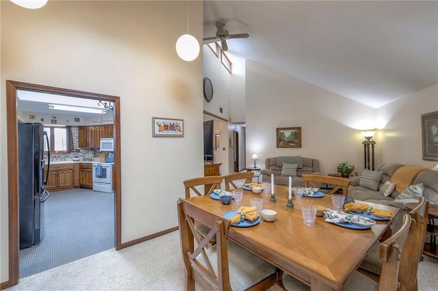 24101 E 223rd St, Harrisonville, MO 64701 - dining space featuring high vaulted ceiling, baseboards, light carpet, and ceiling fan
