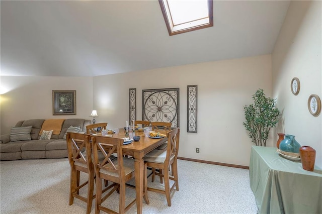 24101 E 223rd St, Harrisonville, MO 64701 - dining area with vaulted ceiling with skylight, baseboards, and light colored carpet