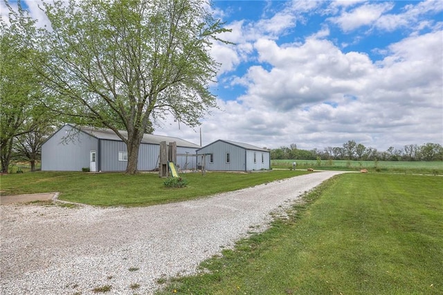 24101 E 223rd St, Harrisonville, MO 64701 - exterior space with a pole building, an outbuilding, and gravel driveway