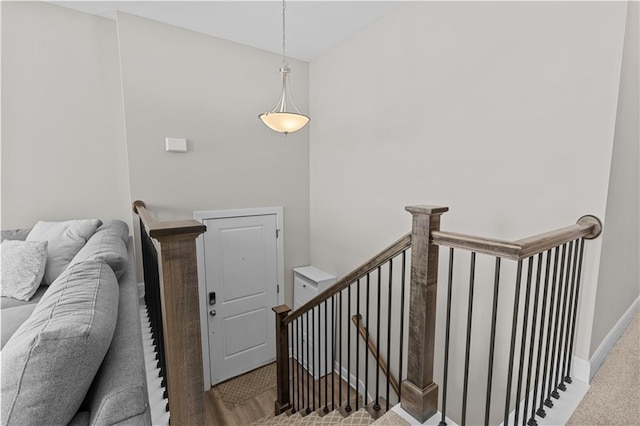 stairs with baseboards and carpet flooring