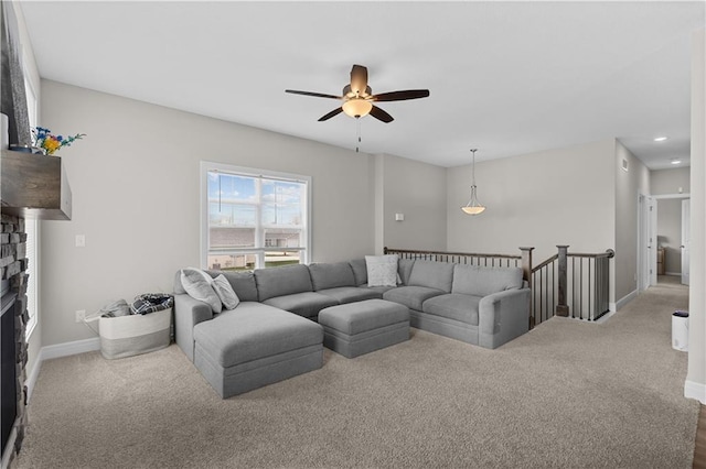 carpeted living area with baseboards, a fireplace, recessed lighting, and ceiling fan