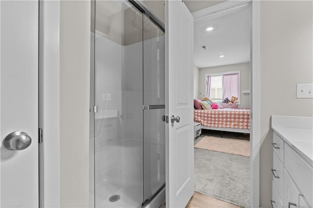 bathroom with visible vents, vanity, connected bathroom, and a stall shower