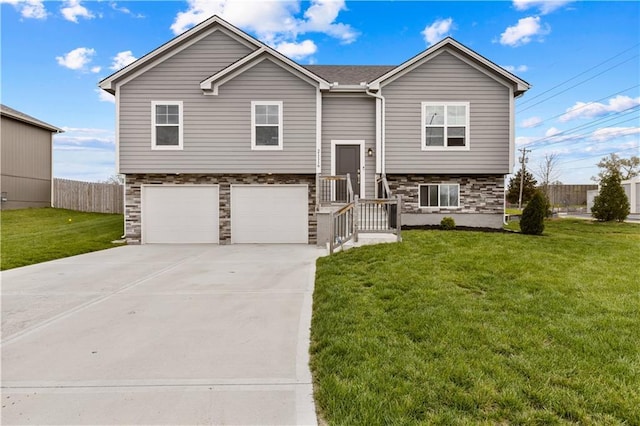 21116 E 8th St S, Independence, MO 64056 - bi-level home featuring stone siding, a garage, and concrete driveway