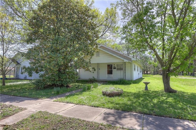 view of front of house with covered porch and a front yard