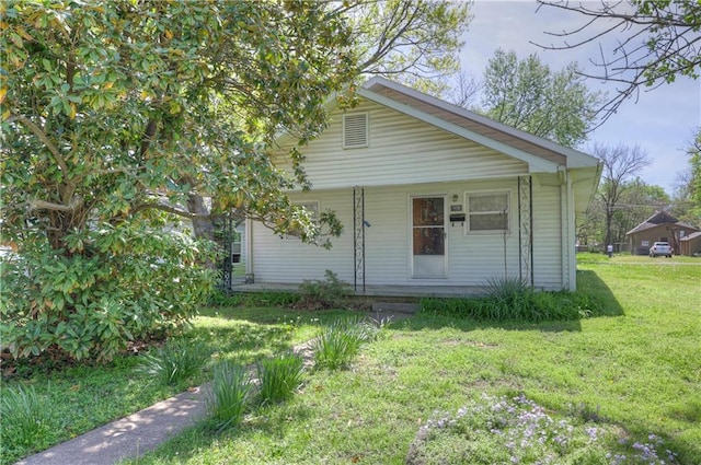 bungalow-style home with a front lawn