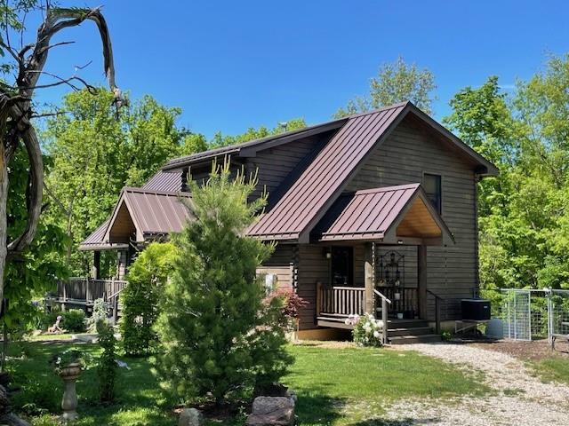 185 SW 51st Rd, Warrensburg, MO 64093 - back of house with a standing seam roof, metal roof, and a lawn
