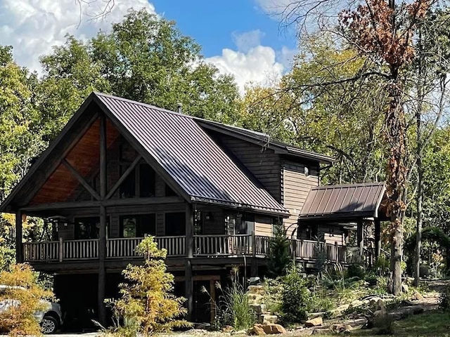 185 SW 51st Rd, Warrensburg, MO 64093 - rear view of property with metal roof, a standing seam roof, and a deck