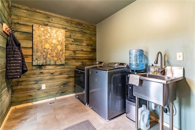 185 SW 51st Rd, Warrensburg, MO 64093 - laundry room with washer and clothes dryer, wooden walls, and tile patterned floors