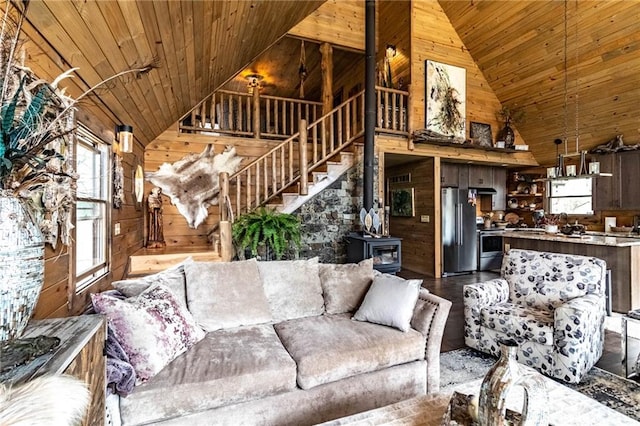 185 SW 51st Rd, Warrensburg, MO 64093 - living room featuring wooden walls, a wood stove, wood ceiling, and high vaulted ceiling