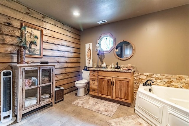 185 SW 51st Rd, Warrensburg, MO 64093 - full bathroom featuring toilet, a bath, vanity, wooden walls, and recessed lighting