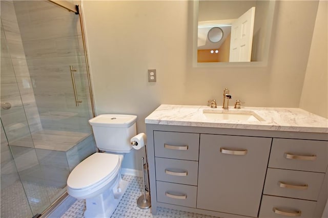 bathroom with a shower stall, toilet, vanity, and tile patterned floors
