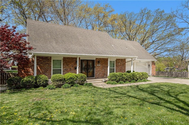 10100 El Monte St, Overland Park, KS 66207 - view of front of house featuring fence, an attached garage, a front lawn, brick siding, and concrete driveway