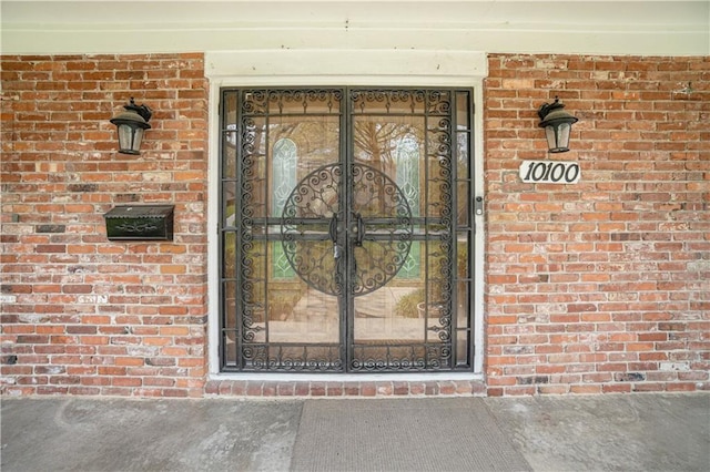 10100 El Monte St, Overland Park, KS 66207 - view of exterior entry with brick siding and french doors