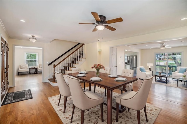 10100 El Monte St, Overland Park, KS 66207 - dining room featuring a ceiling fan, stairs, light wood-style flooring, and a wealth of natural light